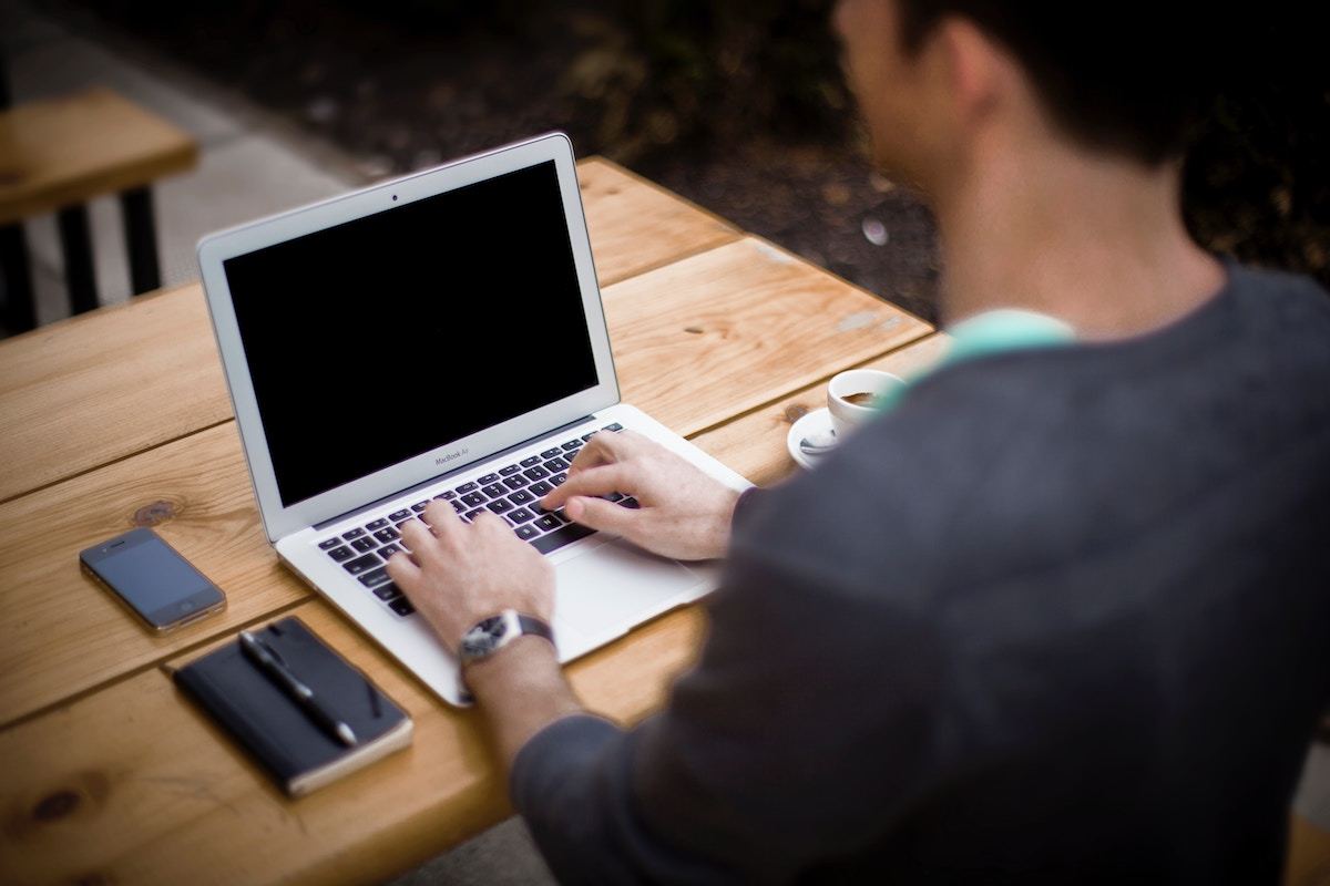 Store owner adding products to an online store on a laptop